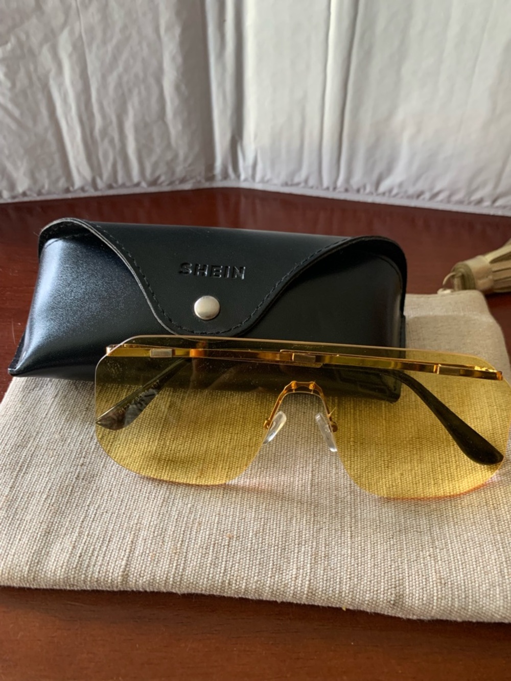 Gold Rimless Shield Sunglasses with Yellow Lenses and Black Case